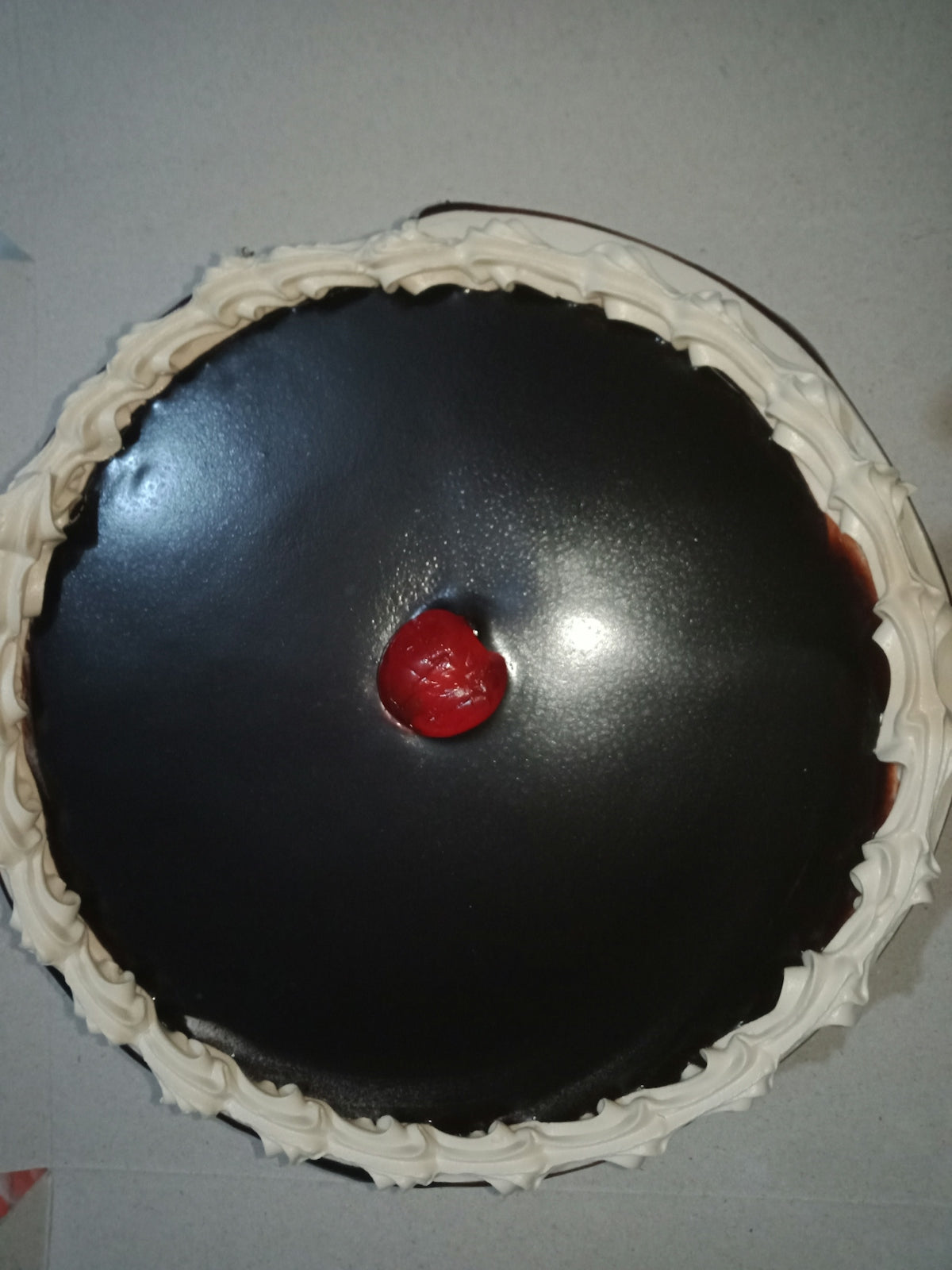 a chocolate cake with a cherry on top of it