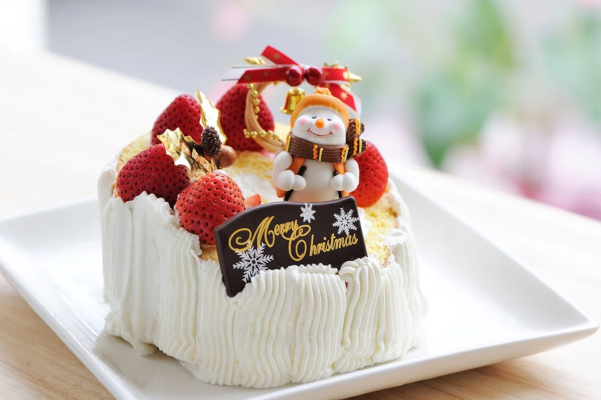 A white plate topped with a cake covered in frosting