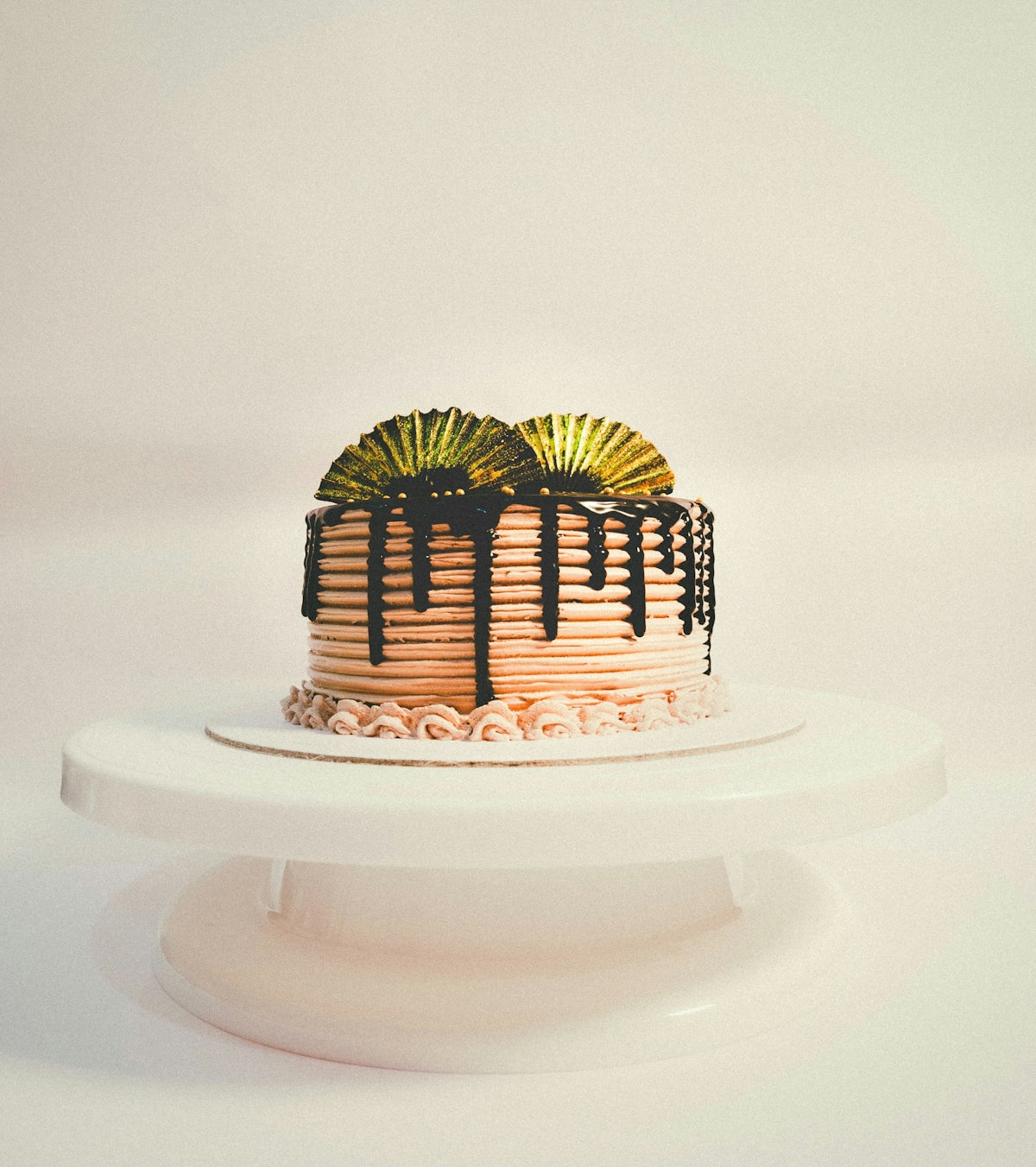 A white cake with chocolate icing and decorations