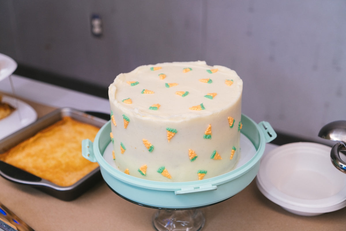 A decorated cake sits on a stand.