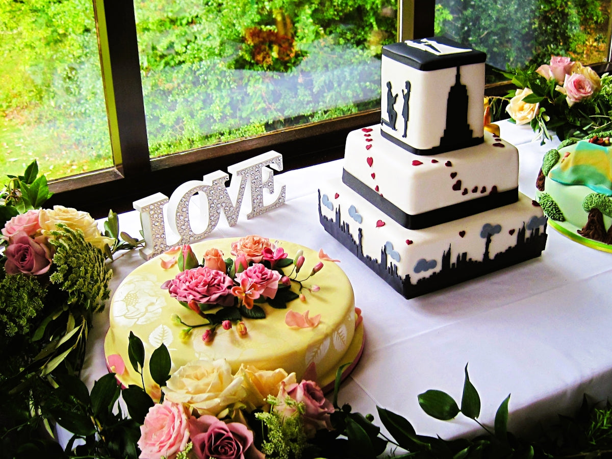 Beautiful wedding cakes sit on a decorated table.