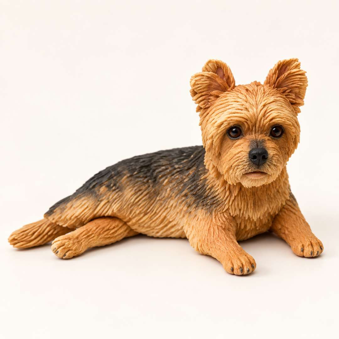 Handmade tan-and-charcoal Yorkshire Terrier figurine lying down, edited from our Etsy example.