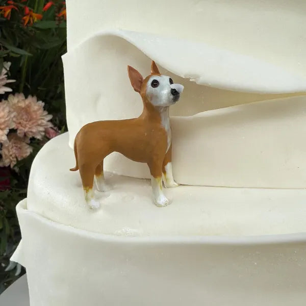 Tan-and-white dog figurine beside a wedding cake tier, from Tyler’s published customer review