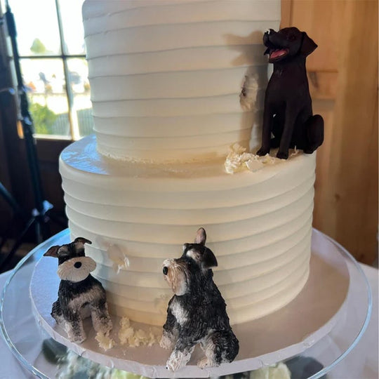 Original wedding cake photo showing two custom Schnauzer figurines and a Labrador; multiple-pet display example