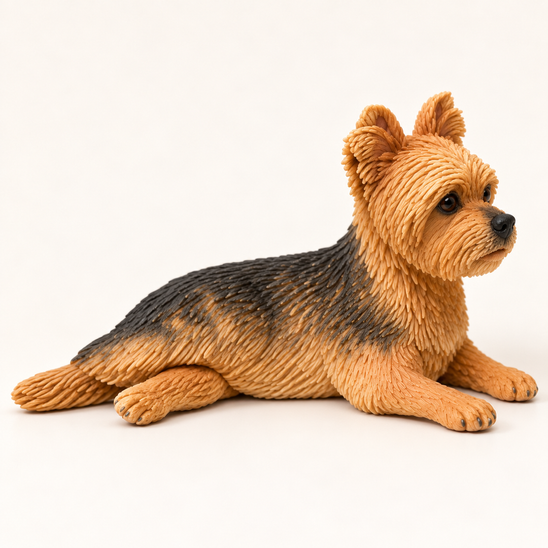 Illustrative side view of a lying Yorkshire Terrier polymer clay figurine.